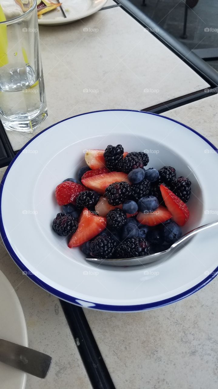 bowl of berries at brunch in white dish