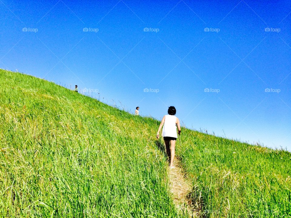 Hiking up a grassy knoll