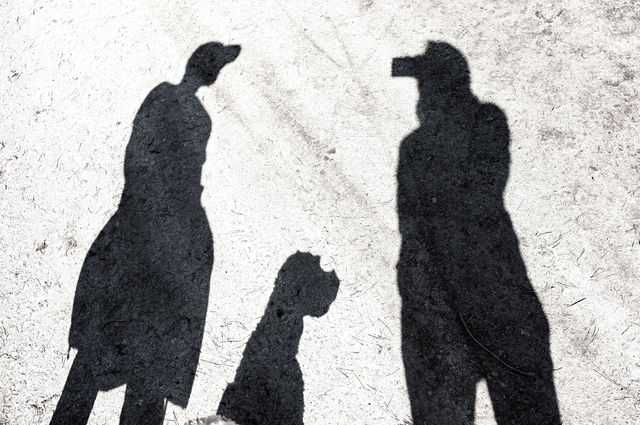 silhouettes of two people and a dog
