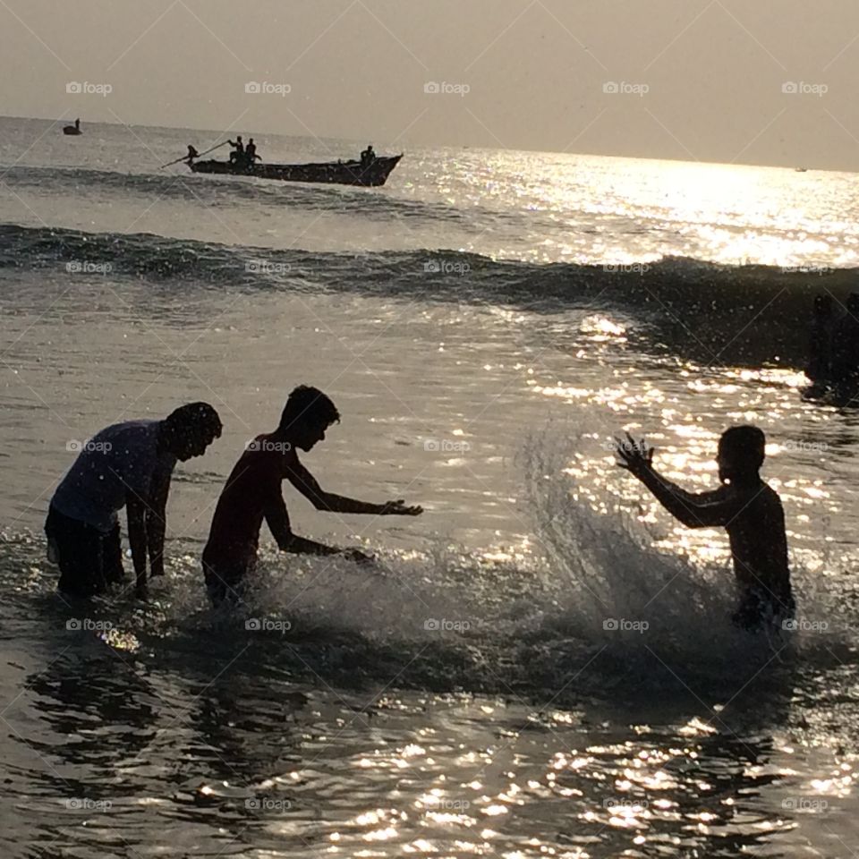 playing guys in beach water, beautiful scenery 