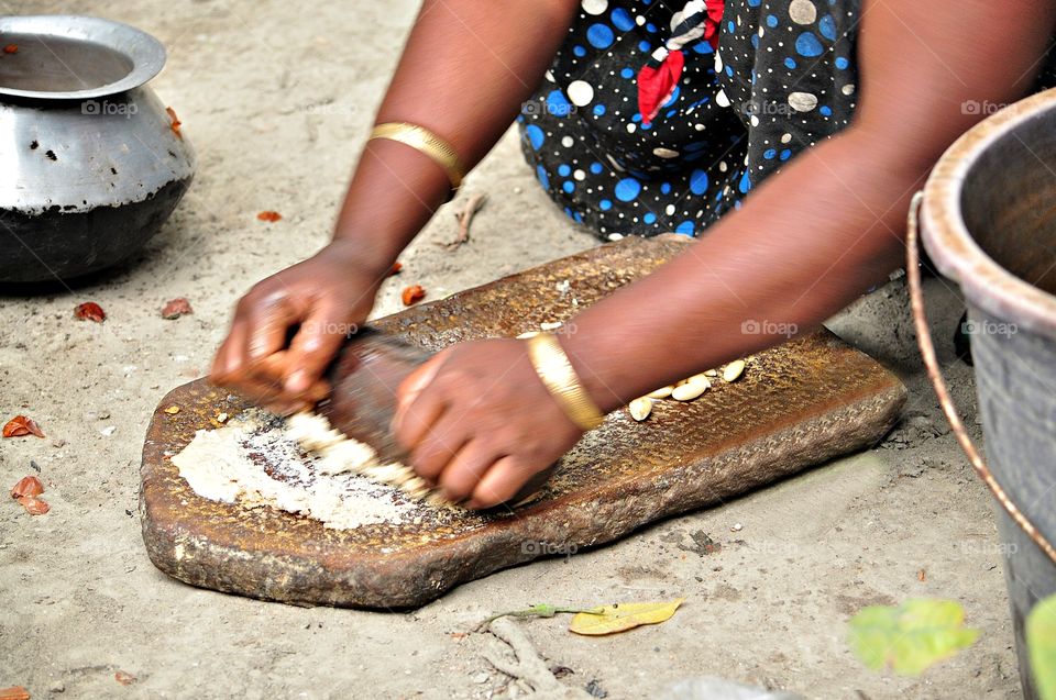 A lady`s making garlic paste for cooking