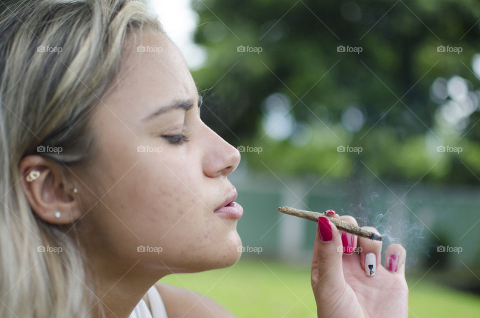Woman smoking cannabis joint