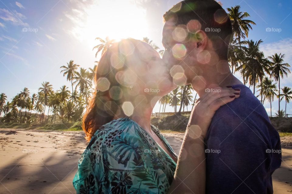 Couple kiss in beautiful sunset on the beach.