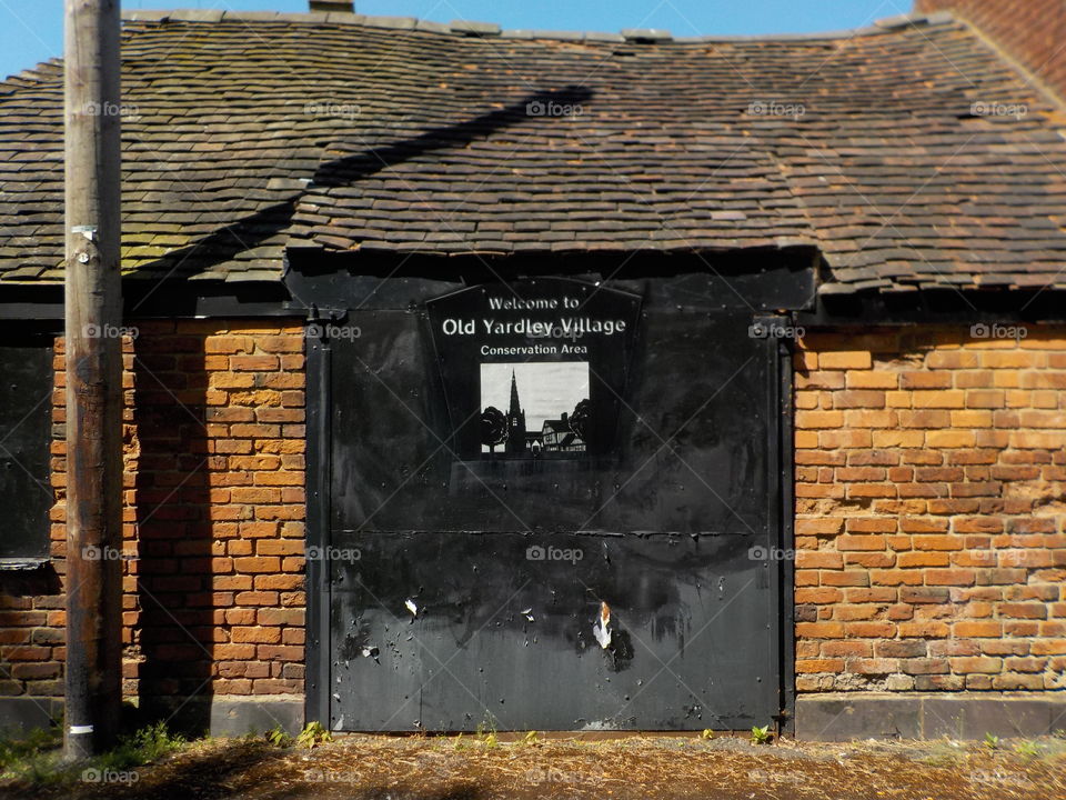 Old building with old village sign 