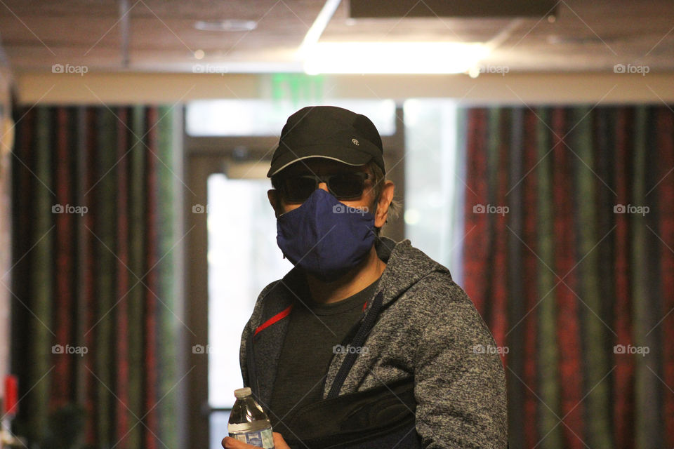 A man wearing face mask indoors in a public place 