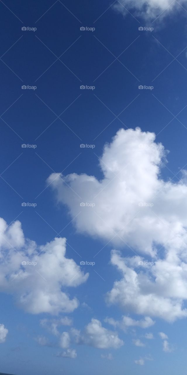 heart shaped cloud in a clear blue sky