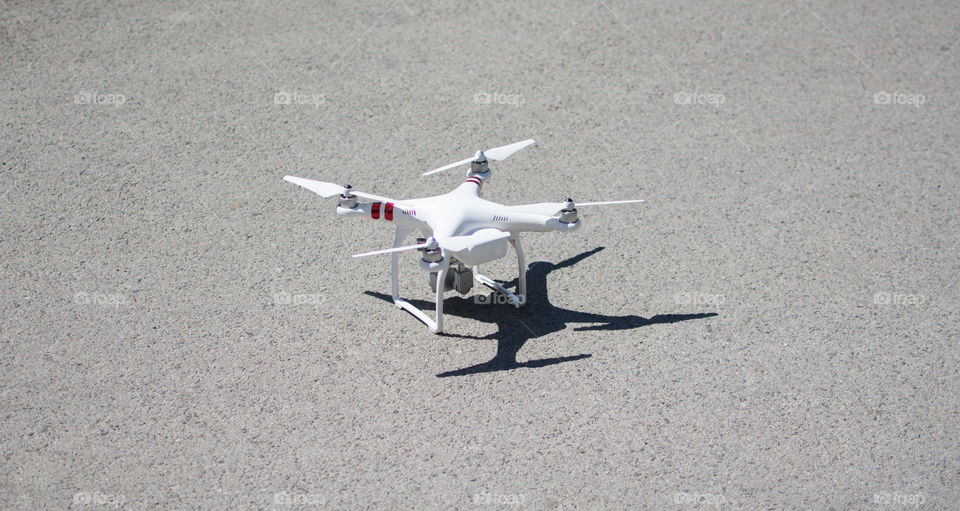 Drone prepairing to fly. Standing on the ground.