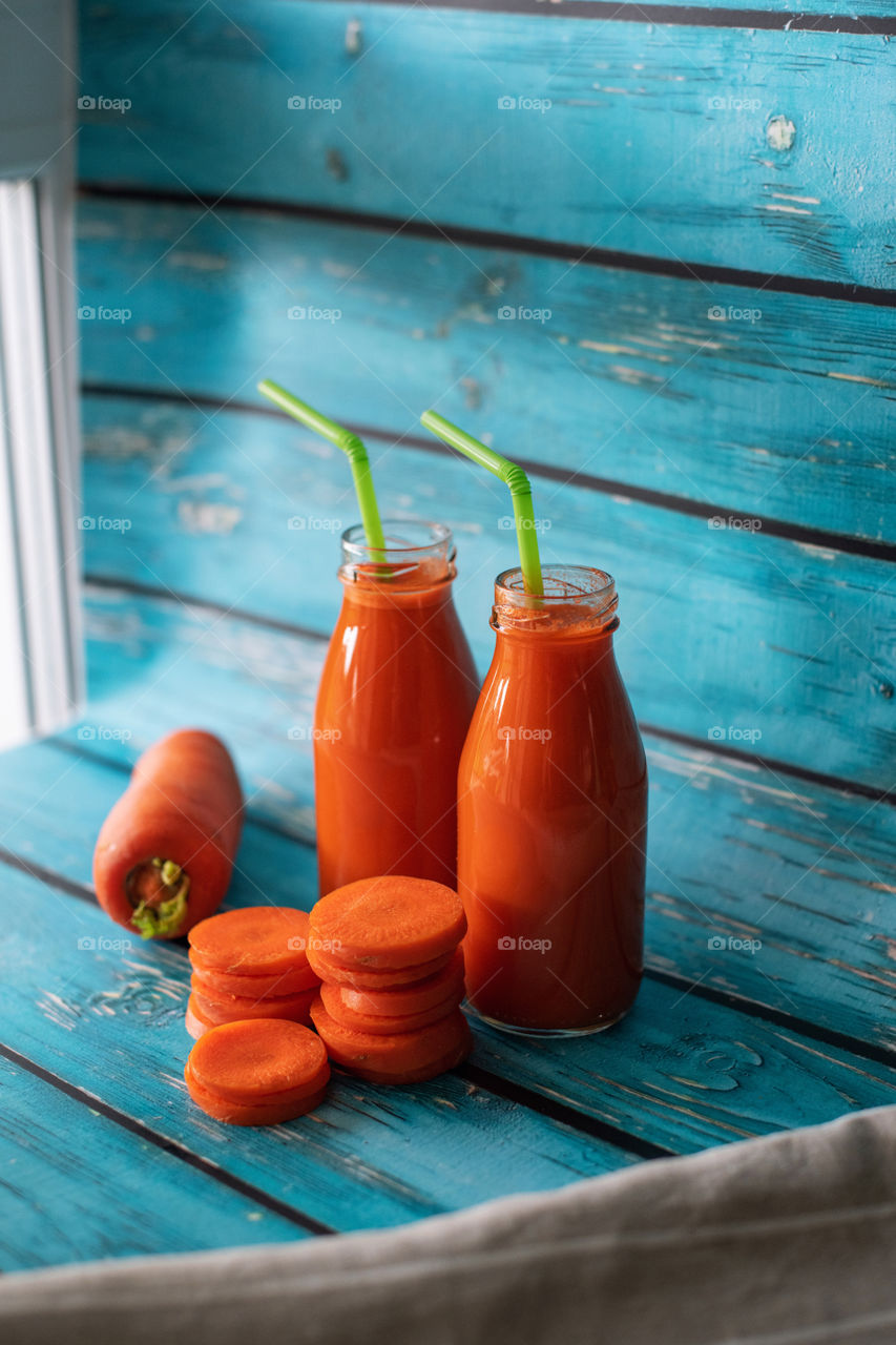 Home made carrot juice. Glass bottles. Healthy vitamin diet. Contrast colors