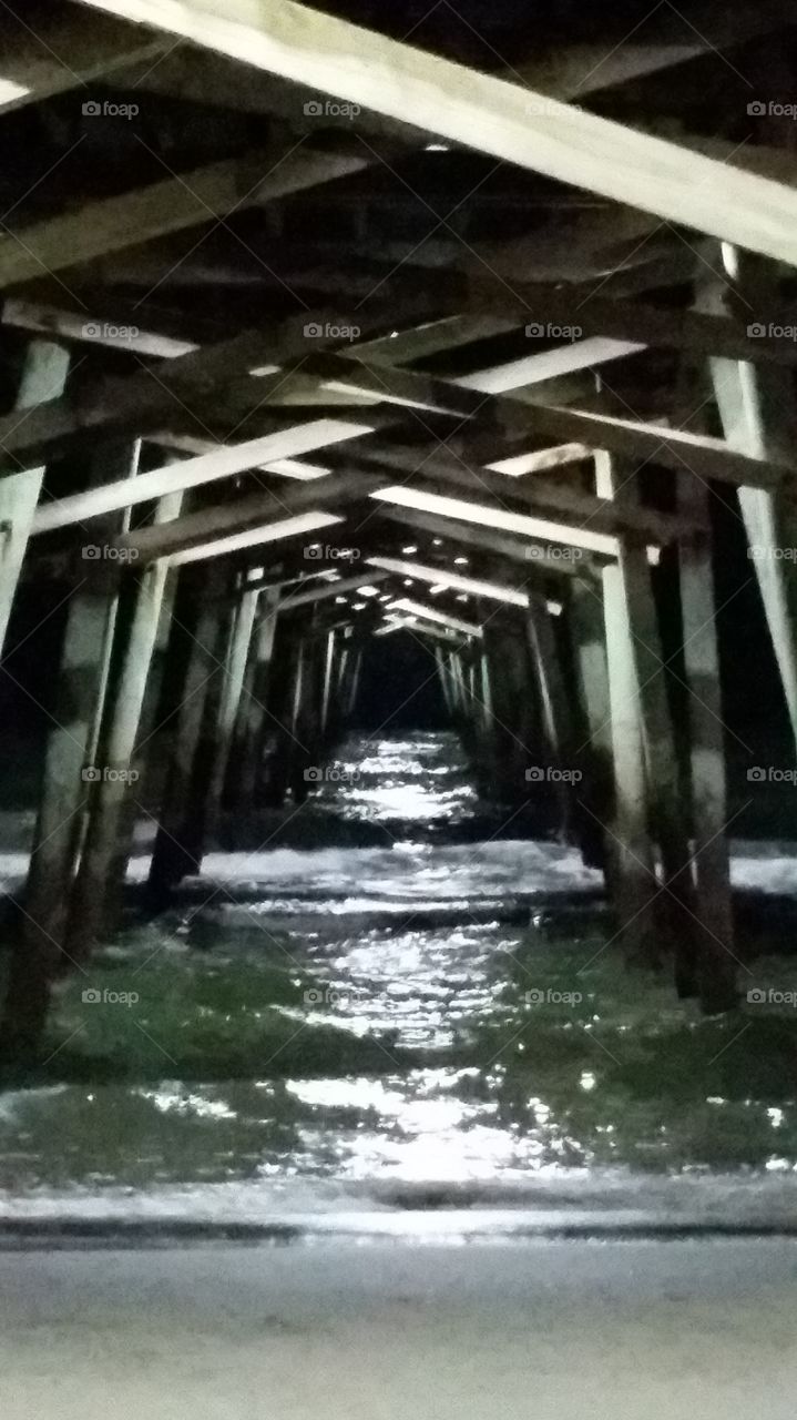 Old Support. This pier has been here for a long while and the beams under it have never given out, allowing us a glimps of the sea.