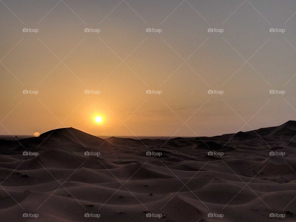 Sunrise (Sunset) at Dawn (Dusk) over the Sand Dunes of the Sahara Desert in Morocco