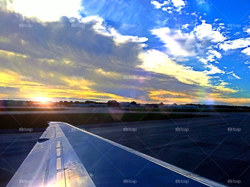 Sunset on the Tarmac . Sunset reflecting off the wing of a jet ready for take off.