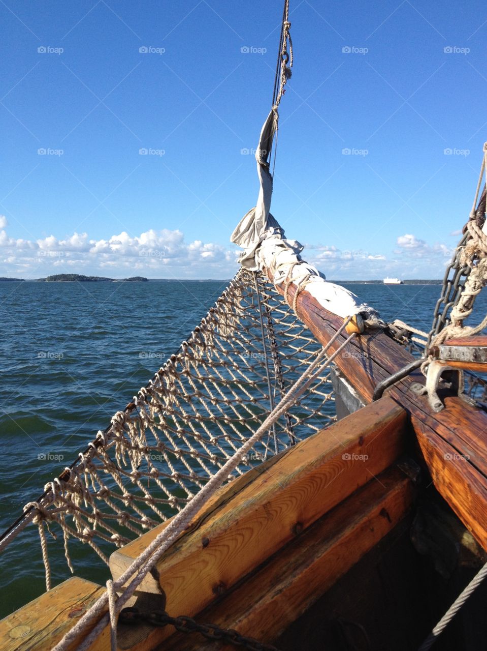 Towards the horison. Sail ship's bowsprit and the lake