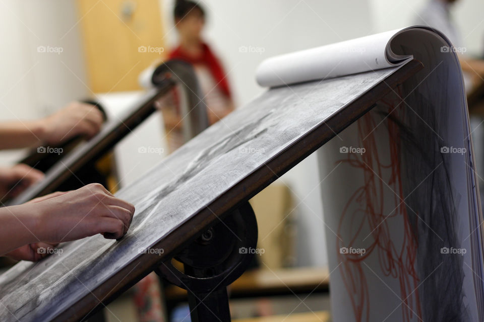 An artist sketches in charcoal in the studio