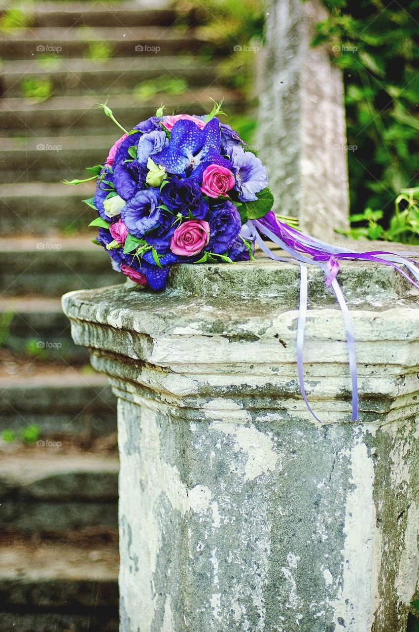 Top view of beautiful wedding bridal bouquet of colorful purple,  pink, red flowers close up.