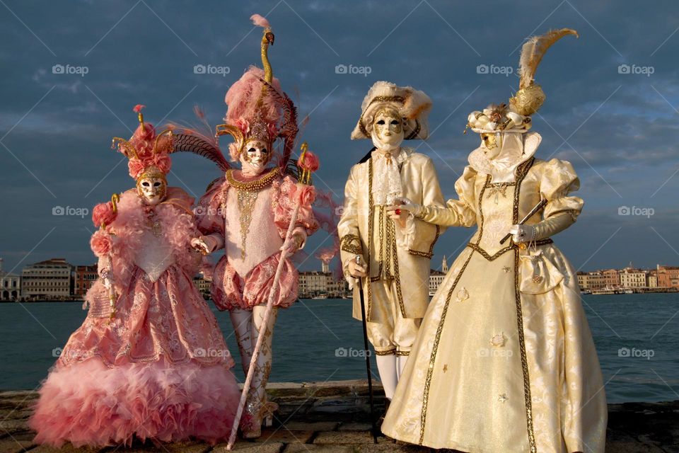 Amazing costumes during Venice carnival with wonderful sunlight