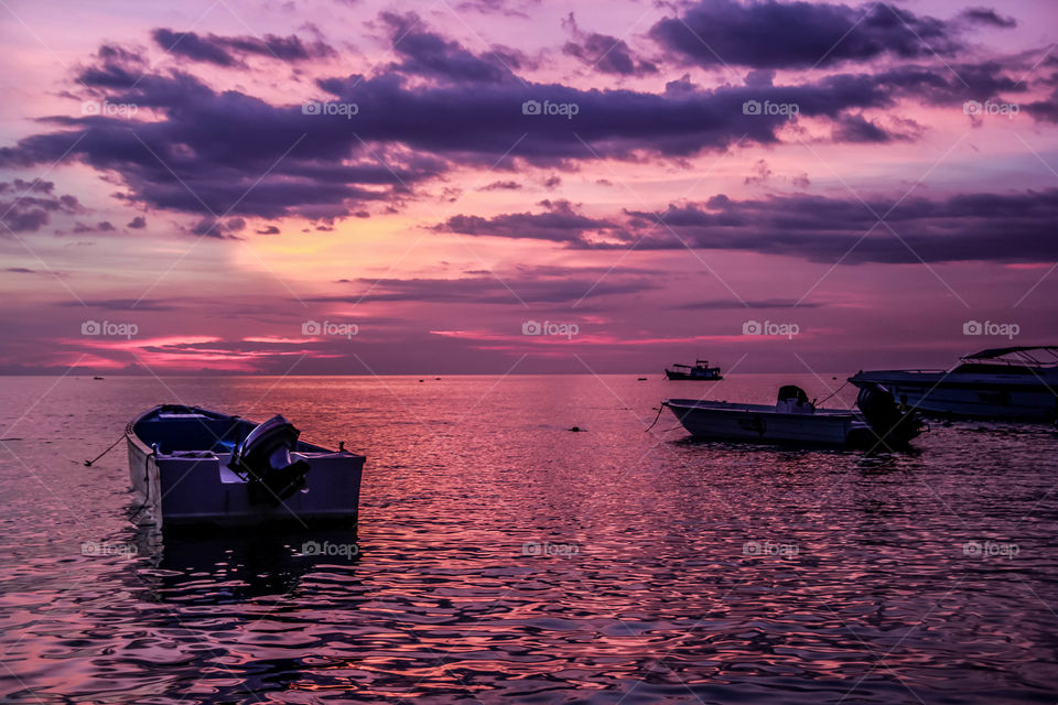 Boat on the sea in sunset time purple sky landscape good view amazing skyline