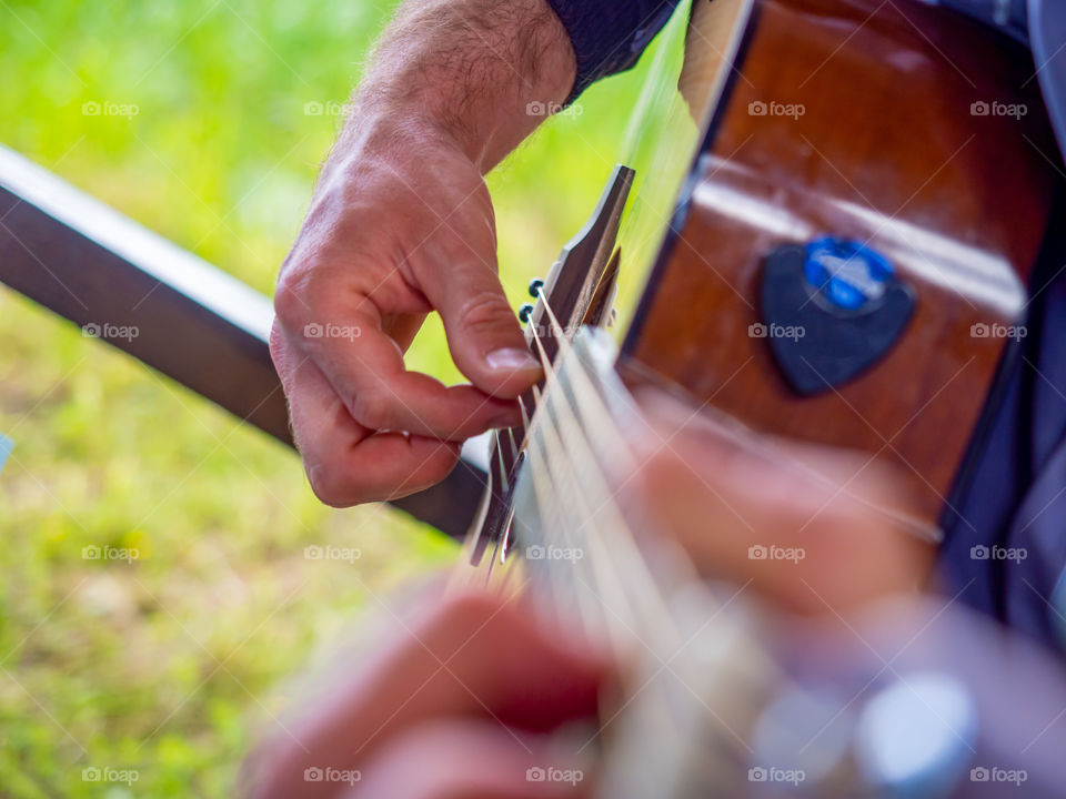 The musician plays the classic acoustic guitar in nature open concert