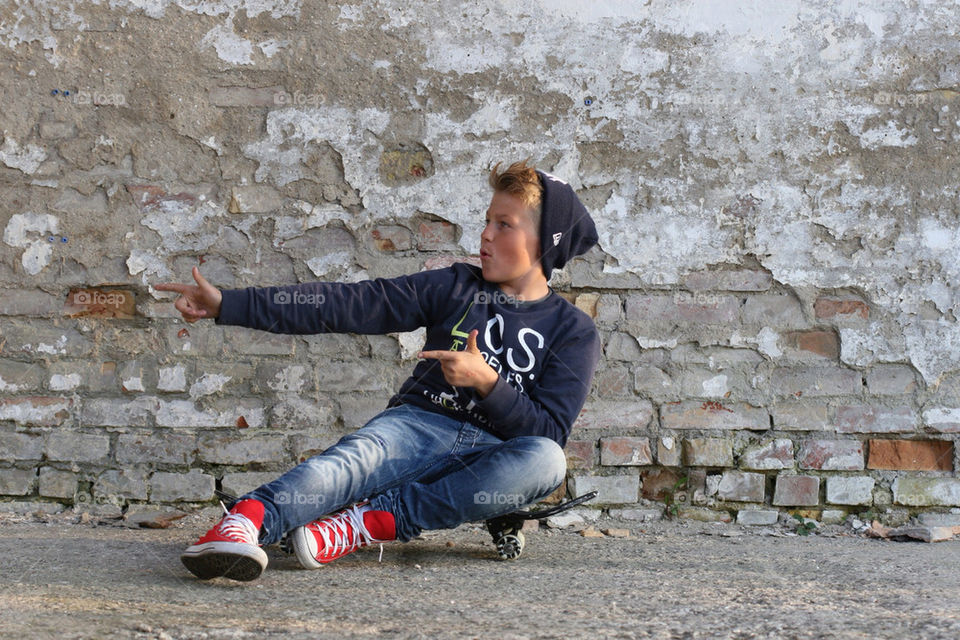 My son axel sitting on a skateboard