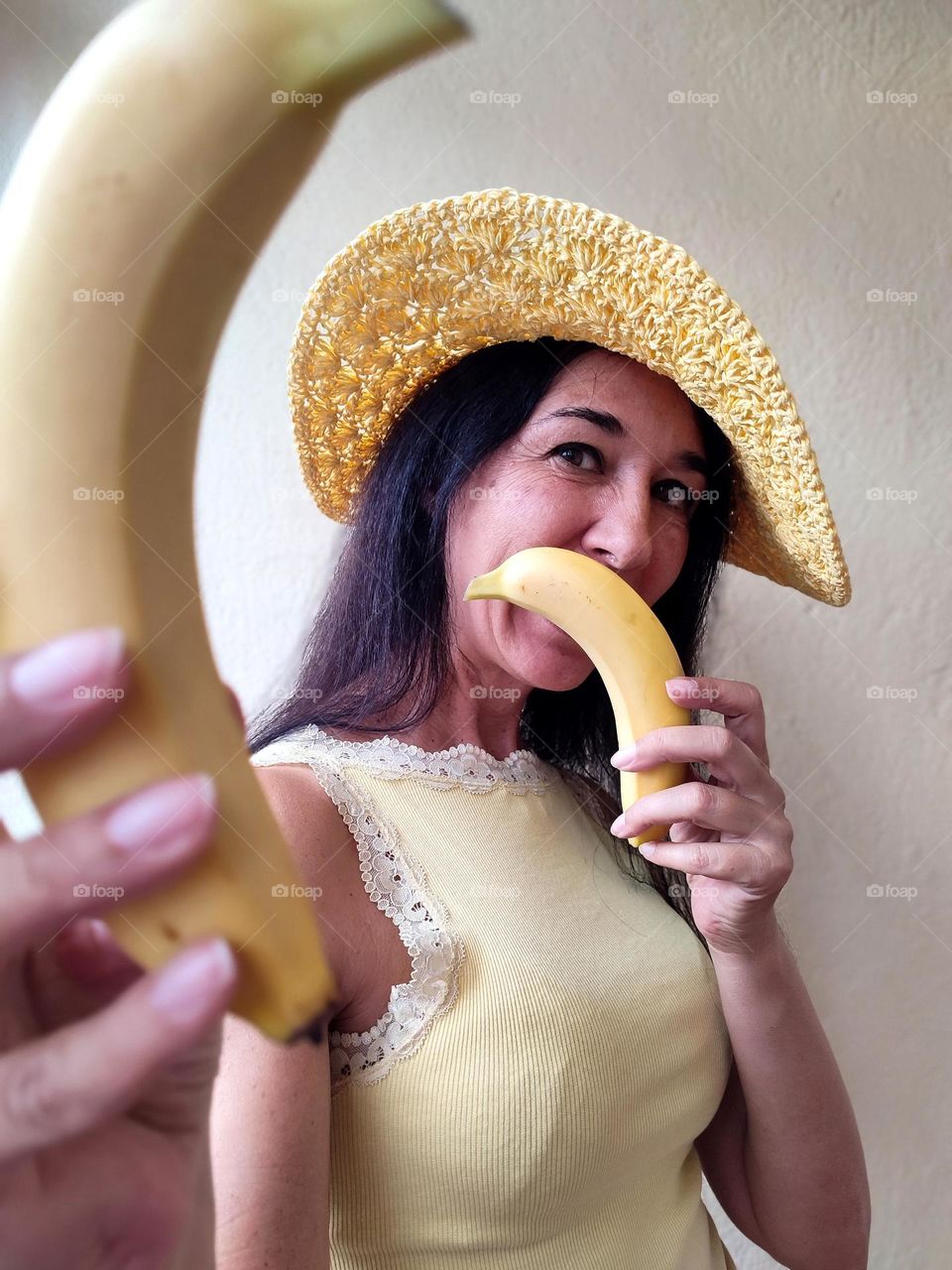 Funny Portrait of Beautiful Smiling Woman with bananas