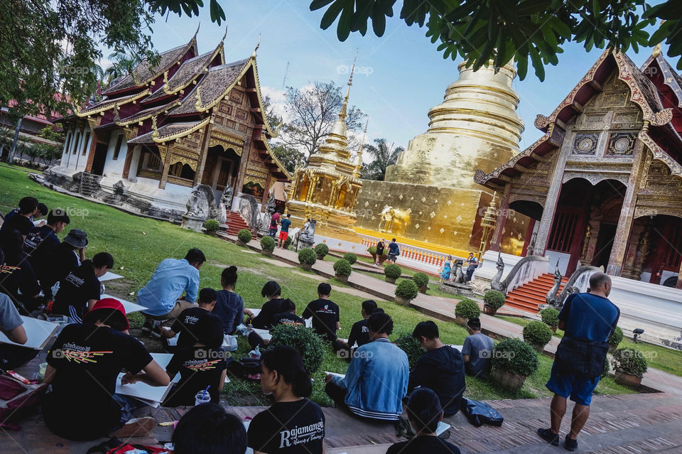 University art class sketching Wat Phra Singh in Chiang Mai, Thailand 