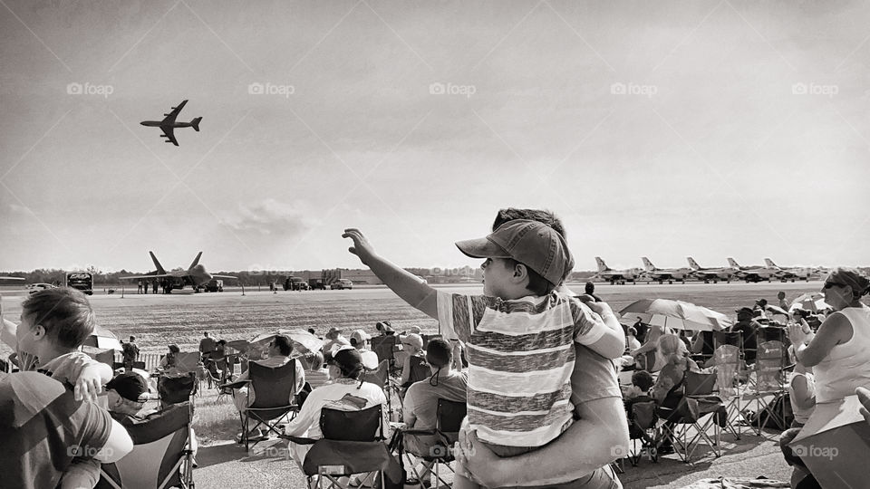 Little boy and father watching airplanes 