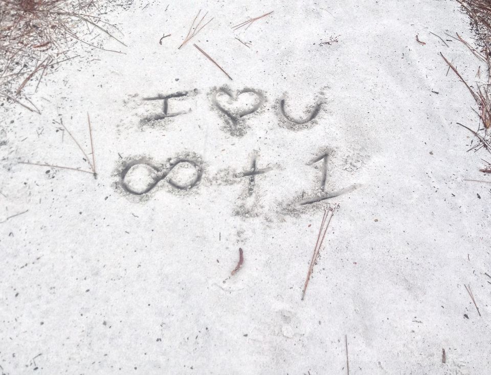 I love you - infinity plus one - written in the beach sand. 