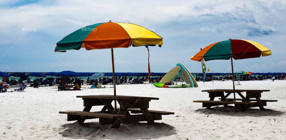 surfboards stacked on beach.