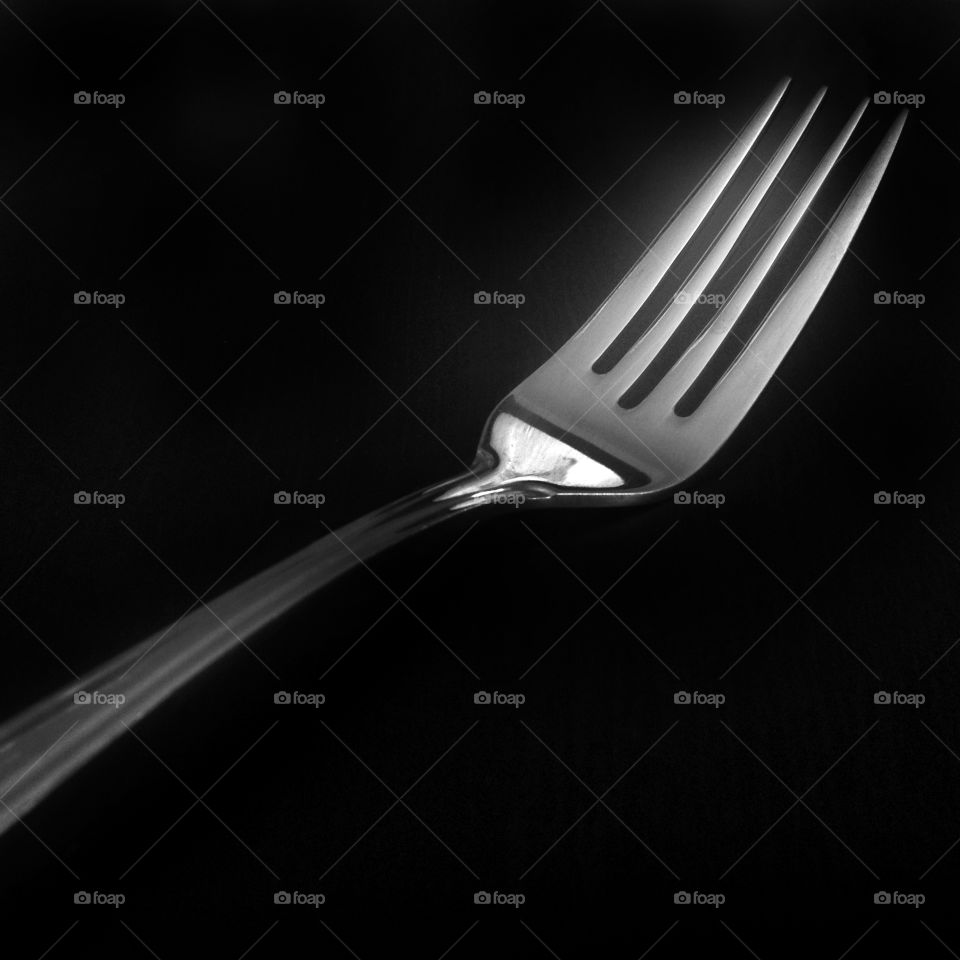 A fork in a black and white square shot