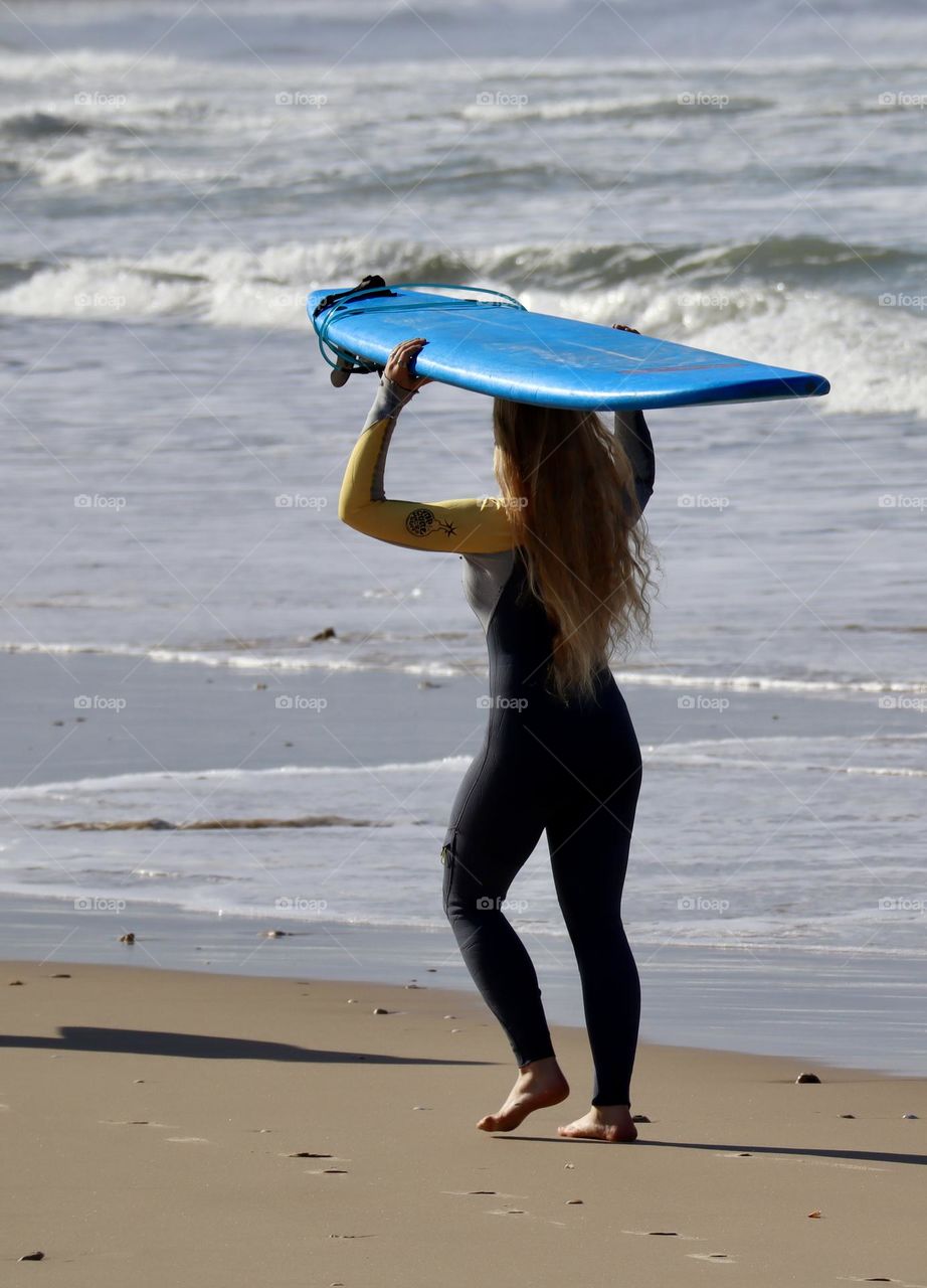 Surfer woman and her surfboard 