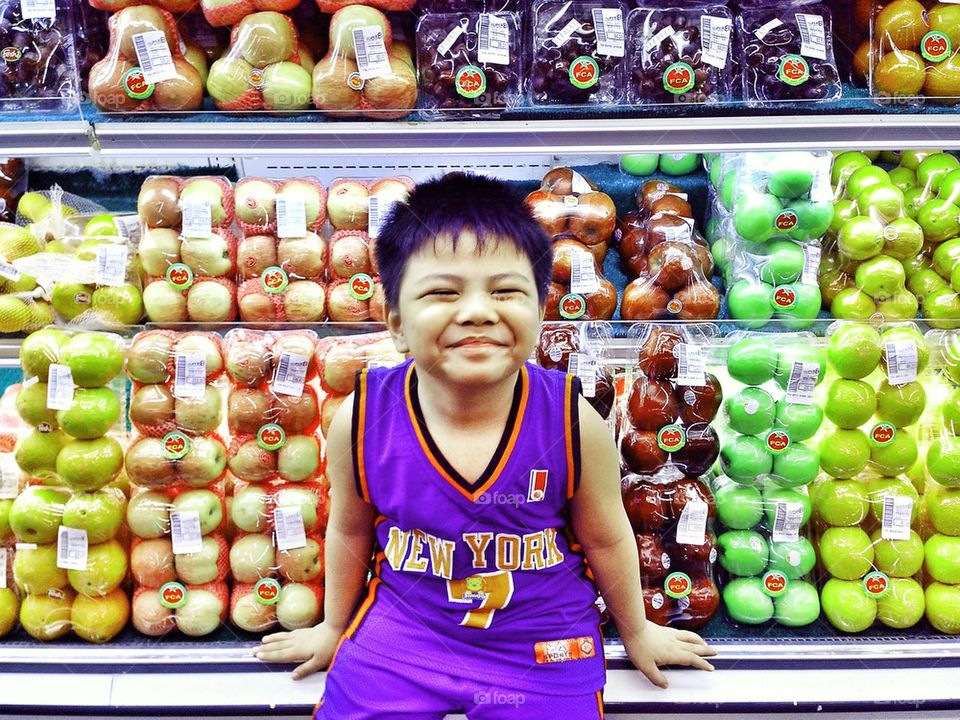 young asian kid in a grocery store