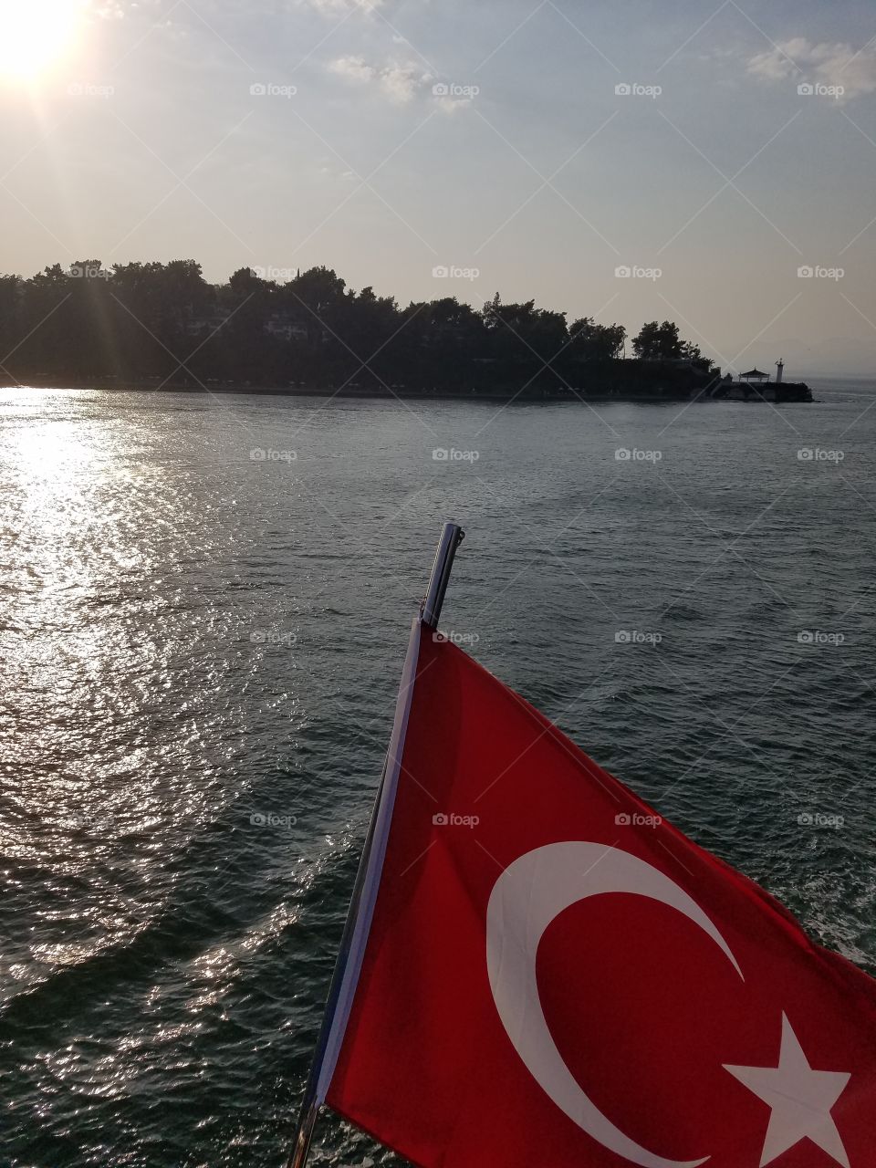 sun setting on a boat tour near fethiye turkey,  flag in the foreground