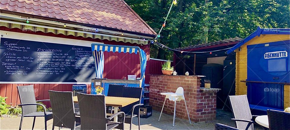 This outside patio is part of a restaurant in “Dranske” on the island “Rügen” in “Mecklenburg - Western Pomerania”, Germany. As we can tell from this photograph dining al fresco has its charm indeed. 2024. Hypnotic Productions