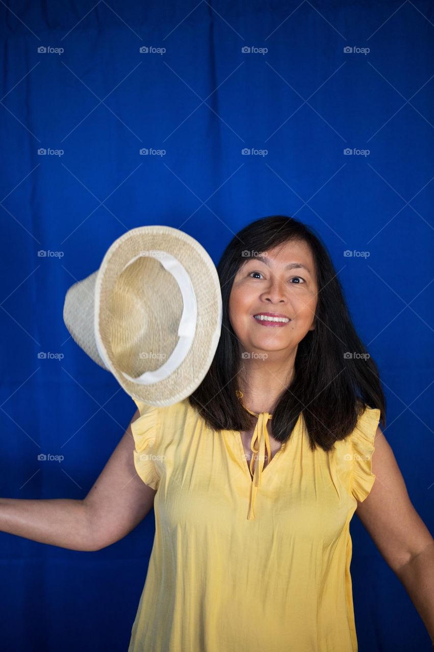 Portrait of a woman having fun with her hat