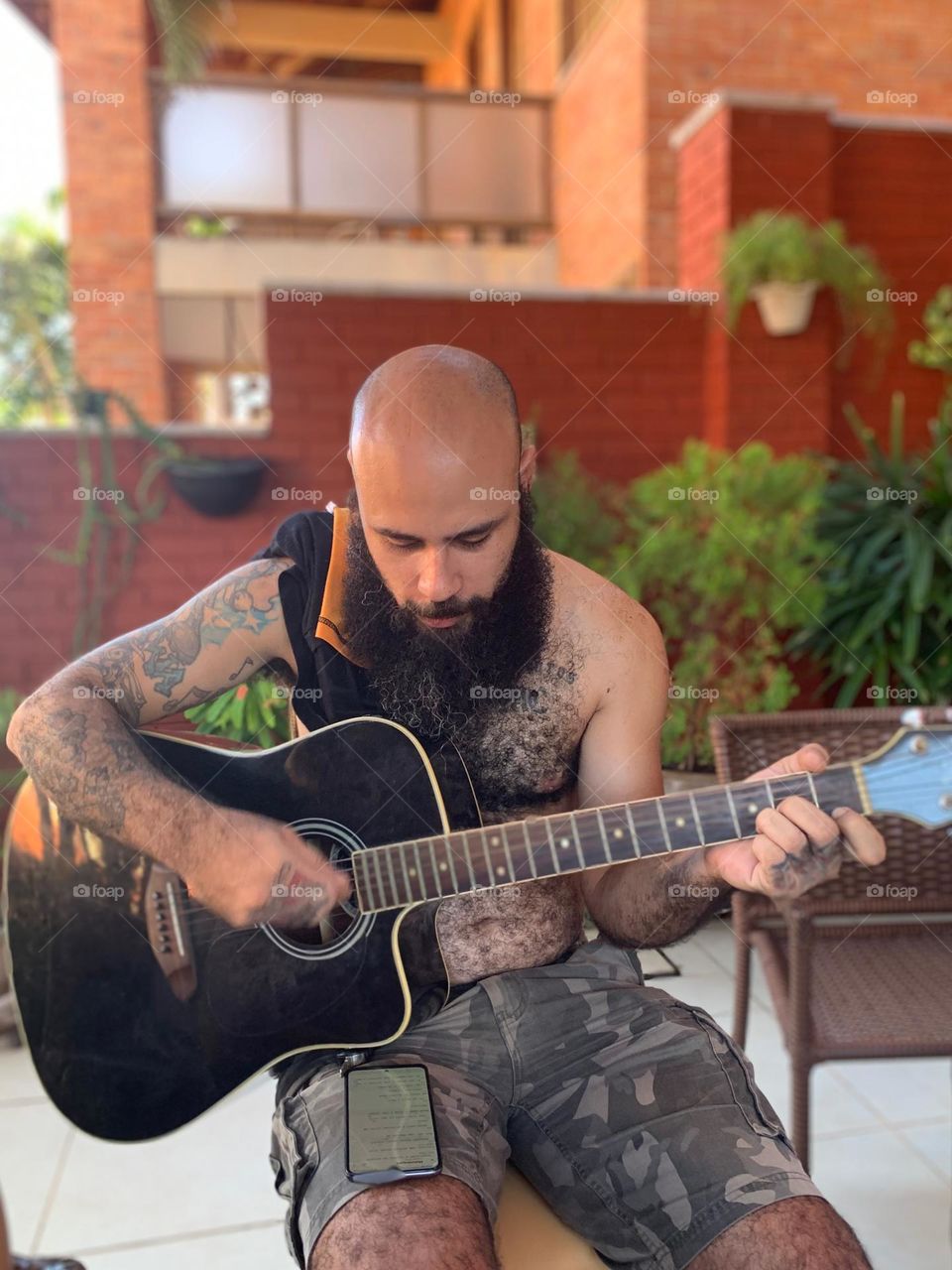 Bearded man playing guitar