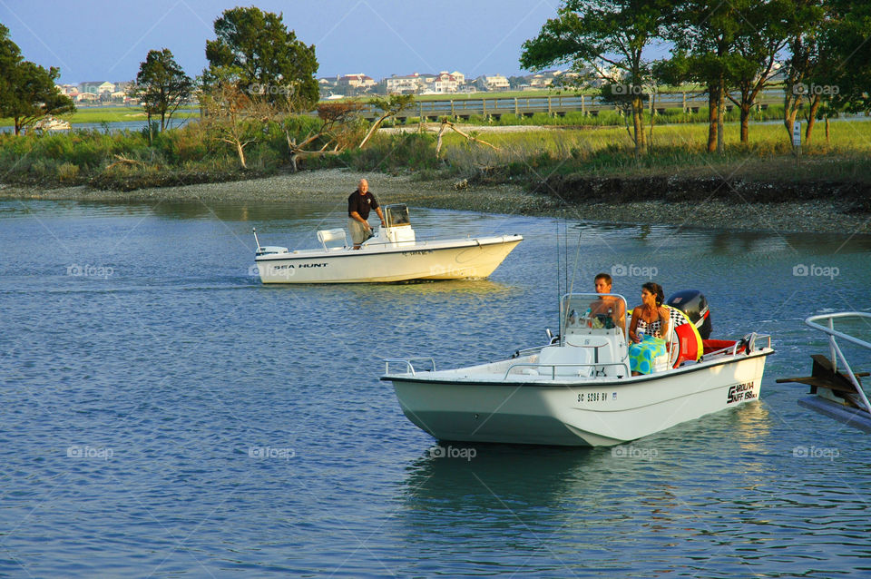 Boaters. Two boats coming into the marsh and Murrells Inlet South Carolina.