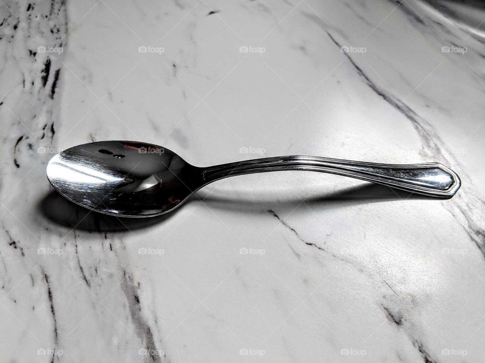 silver spoon on a white countertop