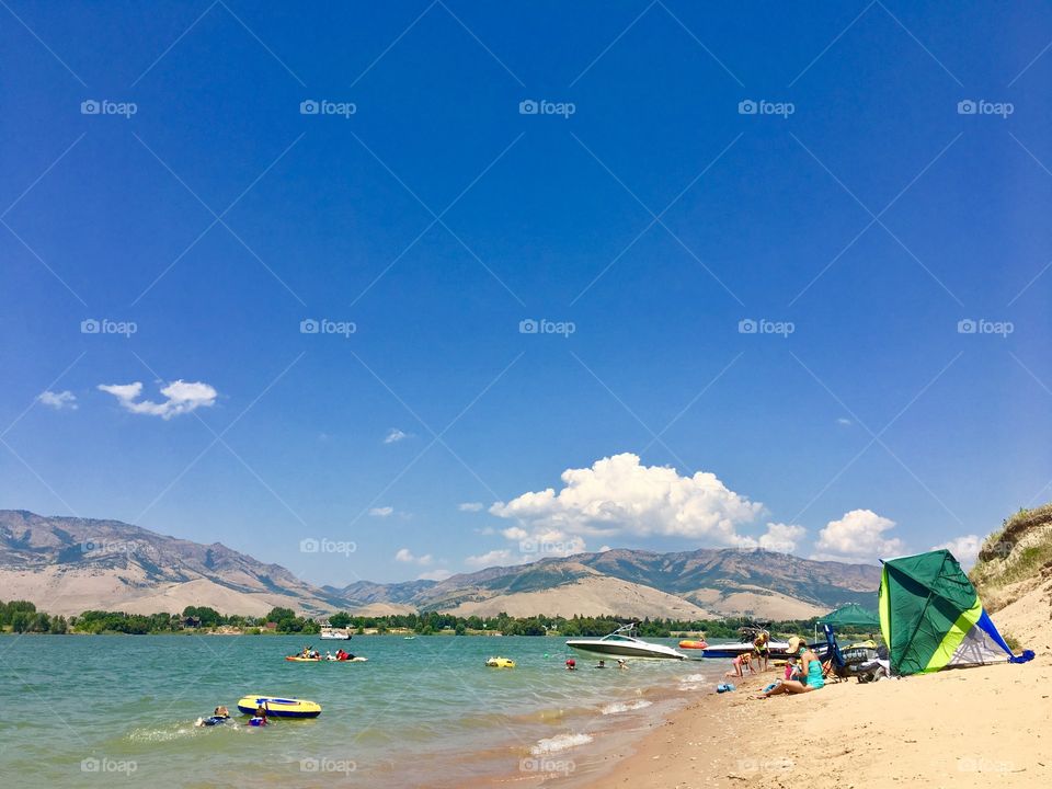 Let the summer vacation begin. Lake vacation. Sand. Boats. Blue skies. Water. Fun.