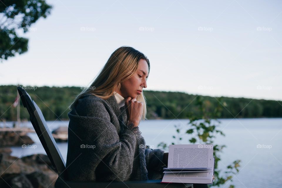 girl reading books in nature