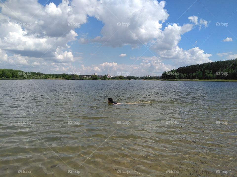 girl swimming in the water  lake summer landscape