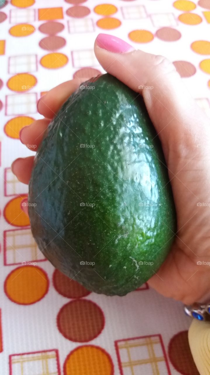 Holding an avocado