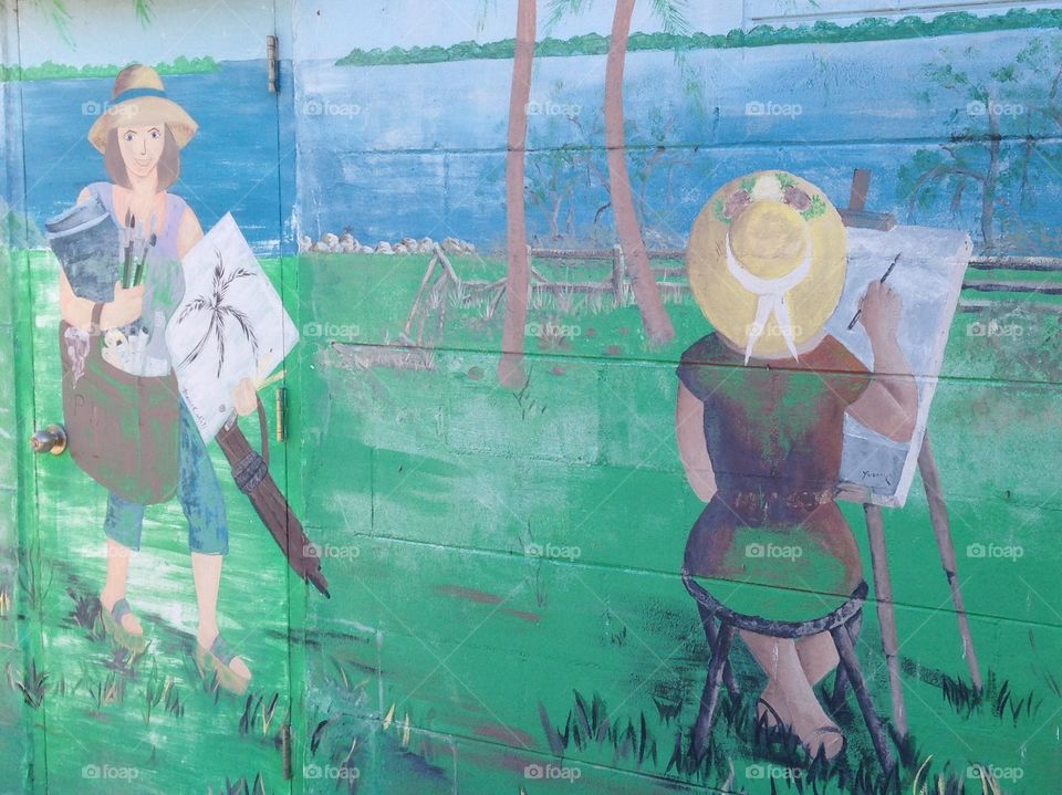 Mural on the outside wall of a building, 2 artists