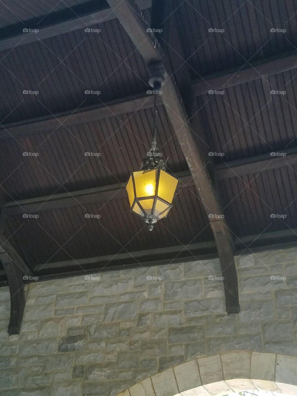 A outdoor chain lamp outside a castle entrance.