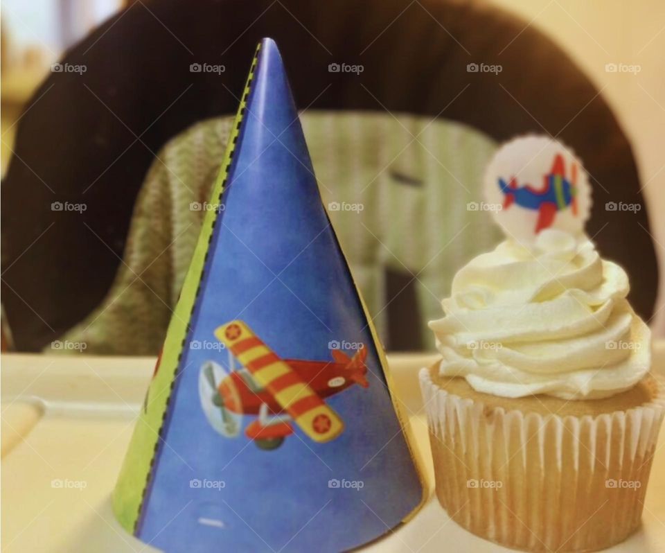 Flying into another birthday with a party hat and cupcake. The theme is airplanes. 