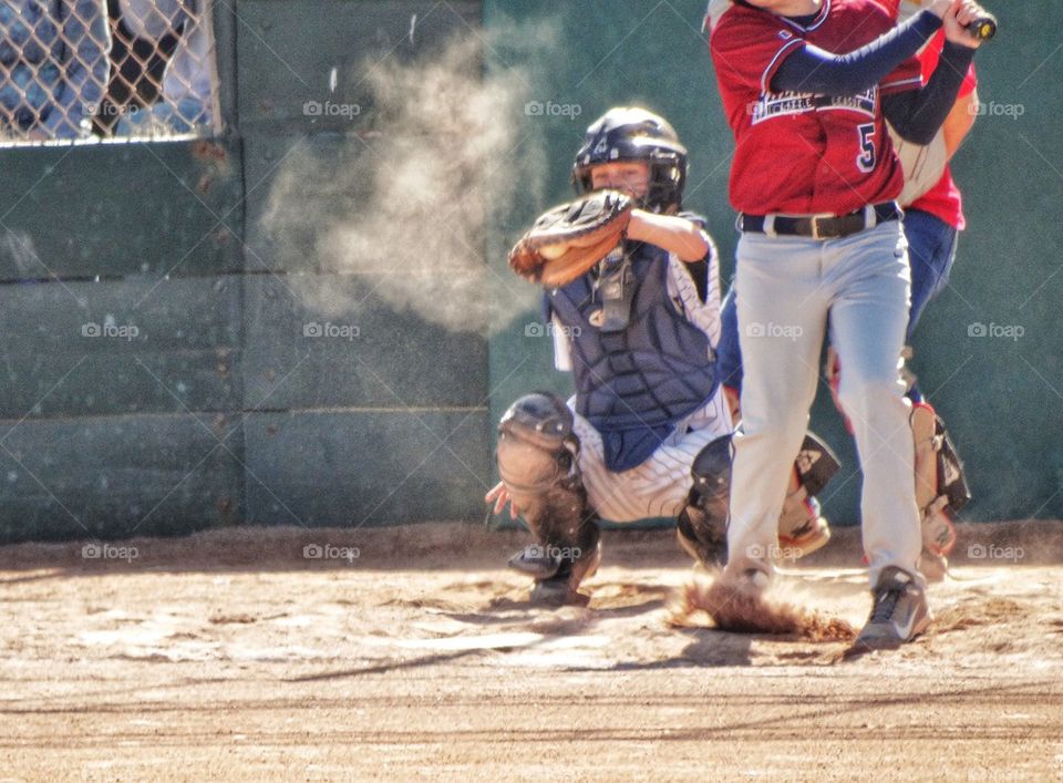 Young Little League Player Catching A Fastball
