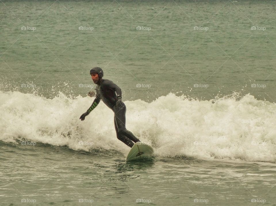 Surfer Gliding In To Shore. California Surfing