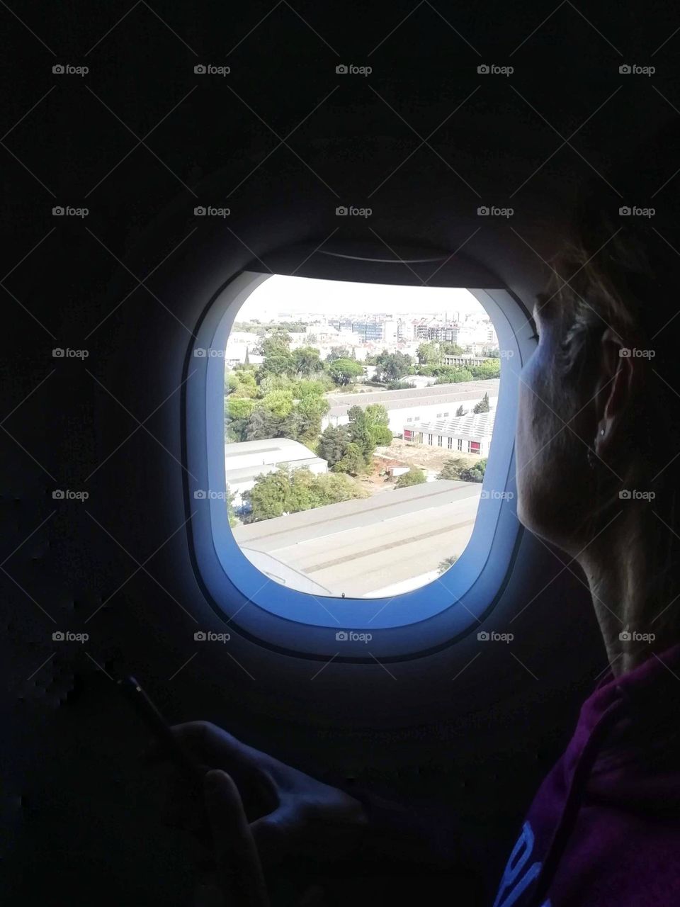 Woman looking out the window of an airplane