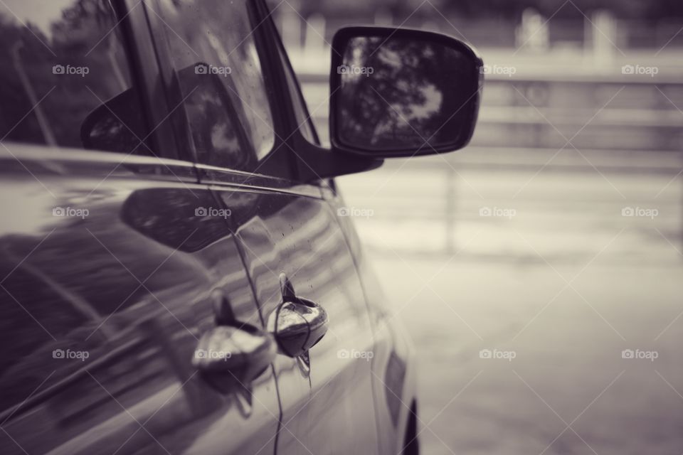 Burgundy van from side view behind