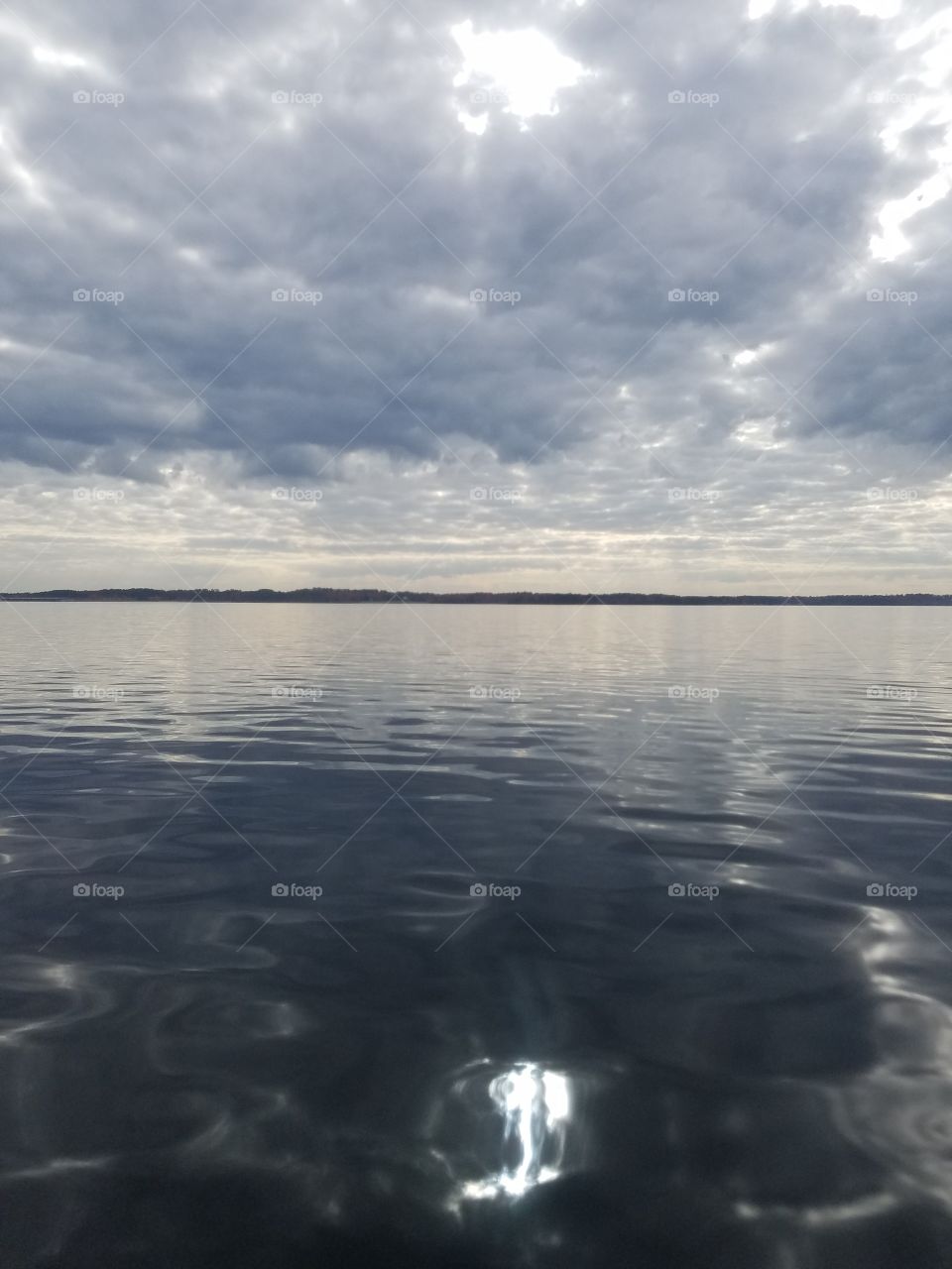 stormy day on the lake. sun reflections  on the water