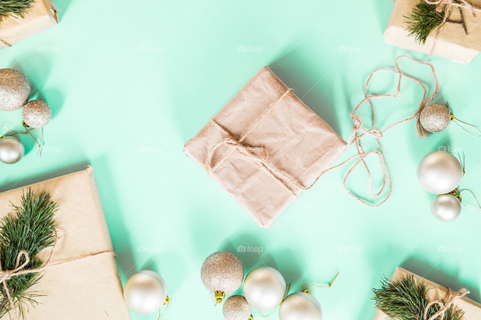 Christmas gift lying on green background. Flatlay items. Flat lay, top view, surprise, happy new year, merry, tree, packing, packed, wrapping, celebrating, holidays, winter, nobody, background 