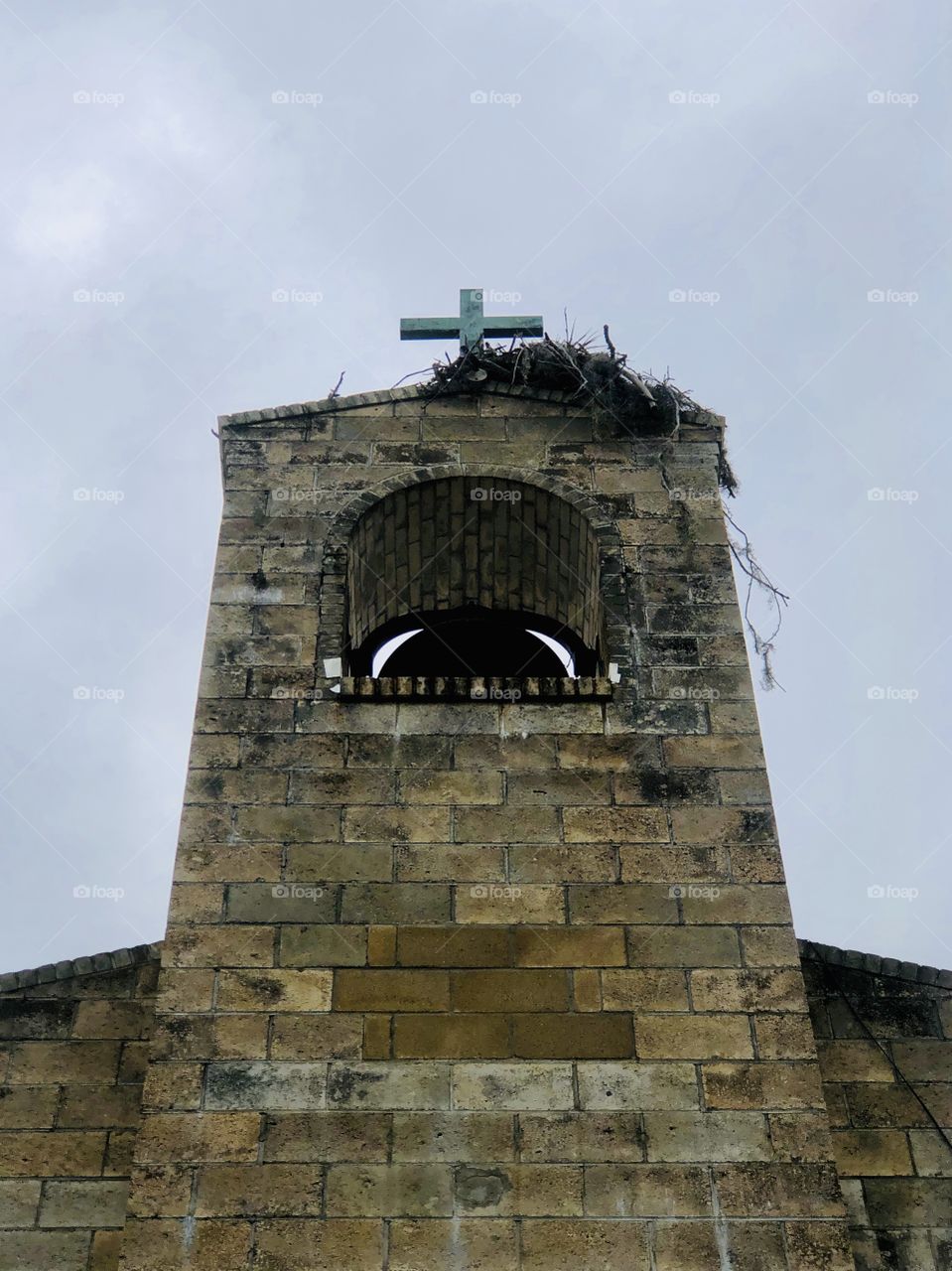 Osprey nest built atop brick church steeple tower 